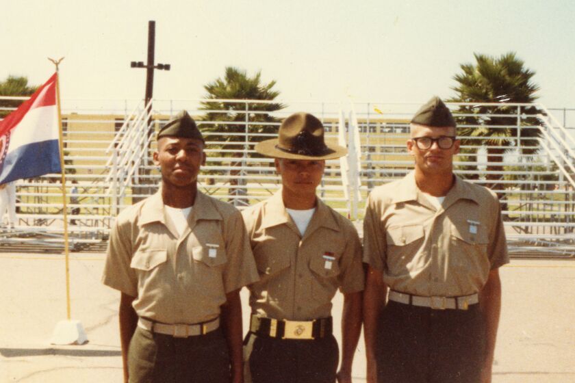 Comedian and TV host Drew Carey (far right), a former U.S. Marine, stands at attention at boot camp graduation. 