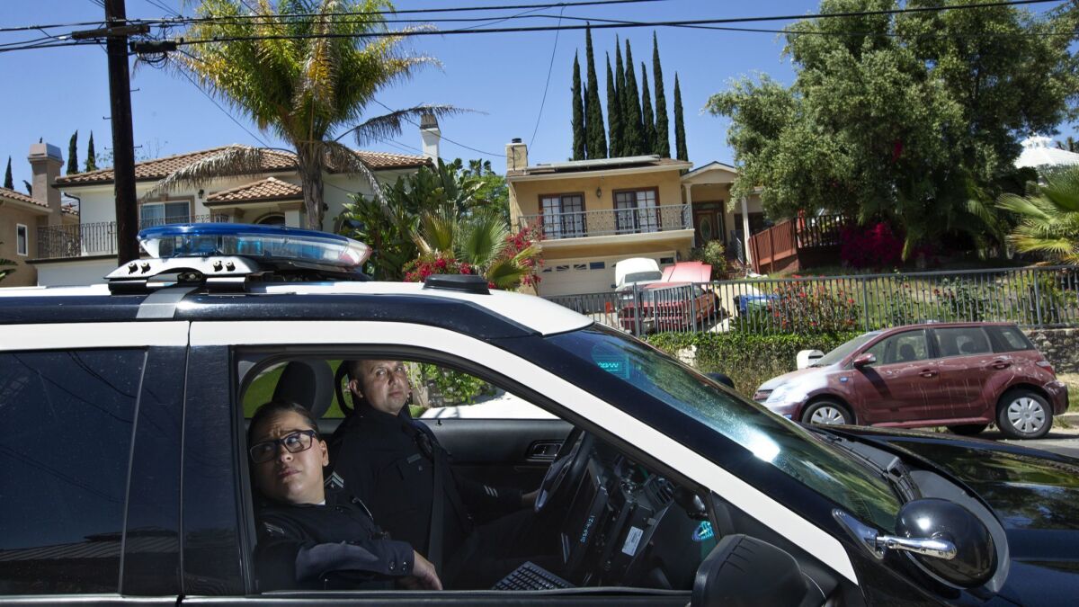 LAPD Senior Lead Officers Denise Vasquez and Oscar Bocanegra patrol an area in the West Valley Division where a computer program predicts property crimes.