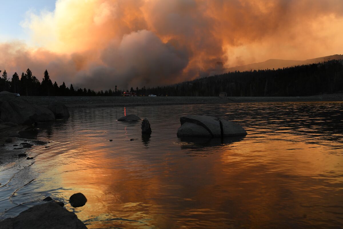  The Caldor fire is reflected off Caples Lake near the Tahoe-area Kirkwood ski resort on Sept. 1. 