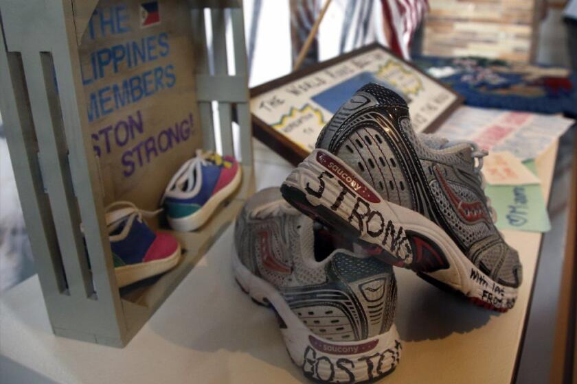 Part of an exhibit entitled "Dear Boston: Messages from the Marathon Memorial" is seen on display last week at the Boston Public Library. Messages of resilience, solidarity, hope and love are embodied at the memorial exhibit commemorating the anniversary of the 2013 Boston Marathon bombings.