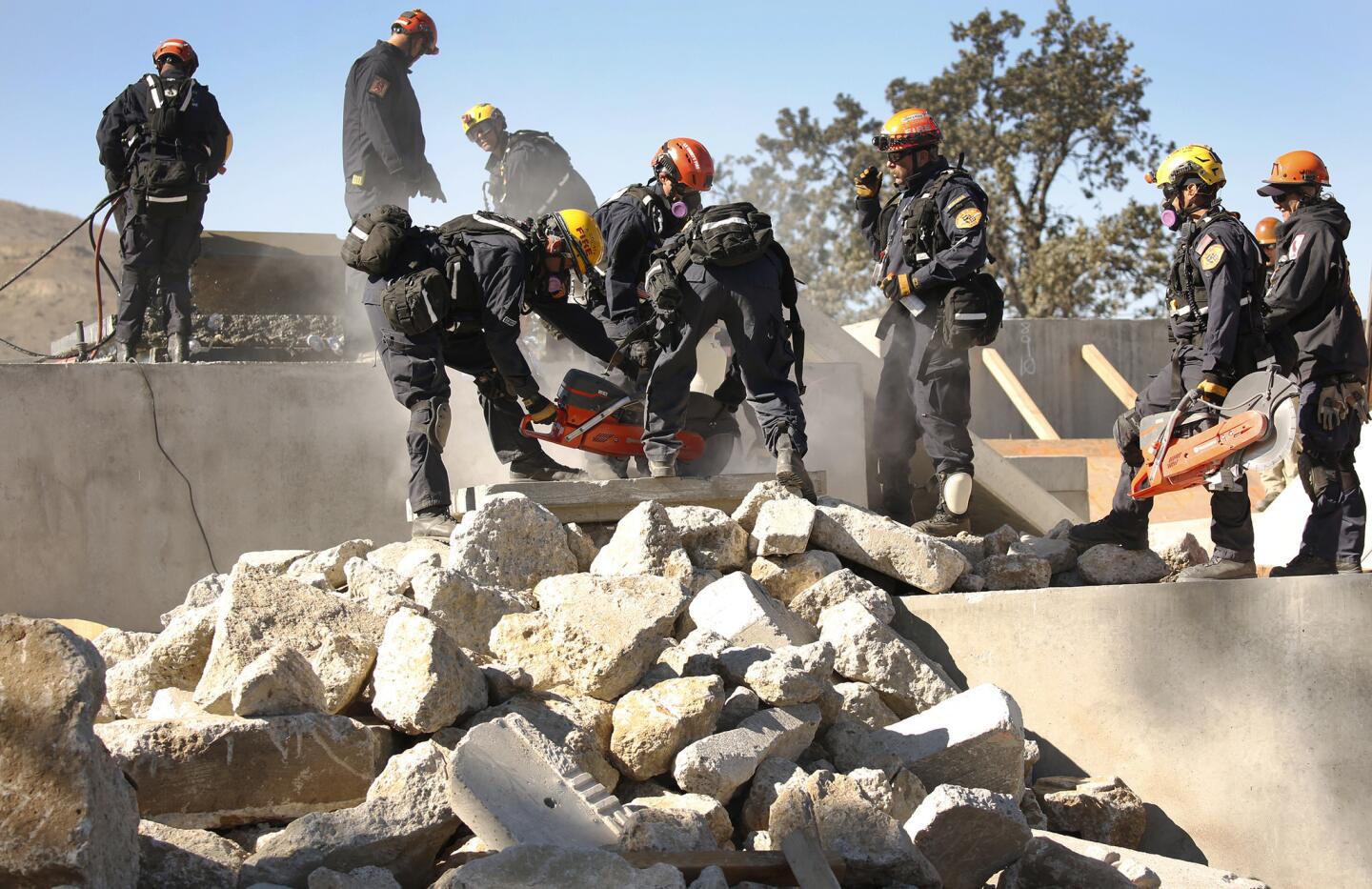 Los Angeles County Fire Department Urban Search and Rescue team members work to locate and extricate victims during a massive earthquake-response exercise hosted by the California National Guard simulating the aftermath of a magnitude 7.8 earthquake.