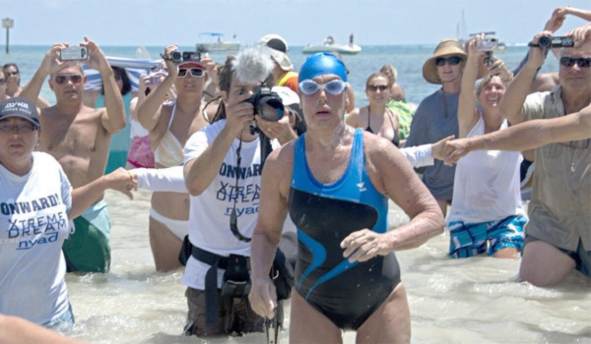 Endurance swimmer Diana Nyad emerges from the water on the coast of Key West, Fla. after completing a 110-mile swim from Cuba to the United States on Monday.