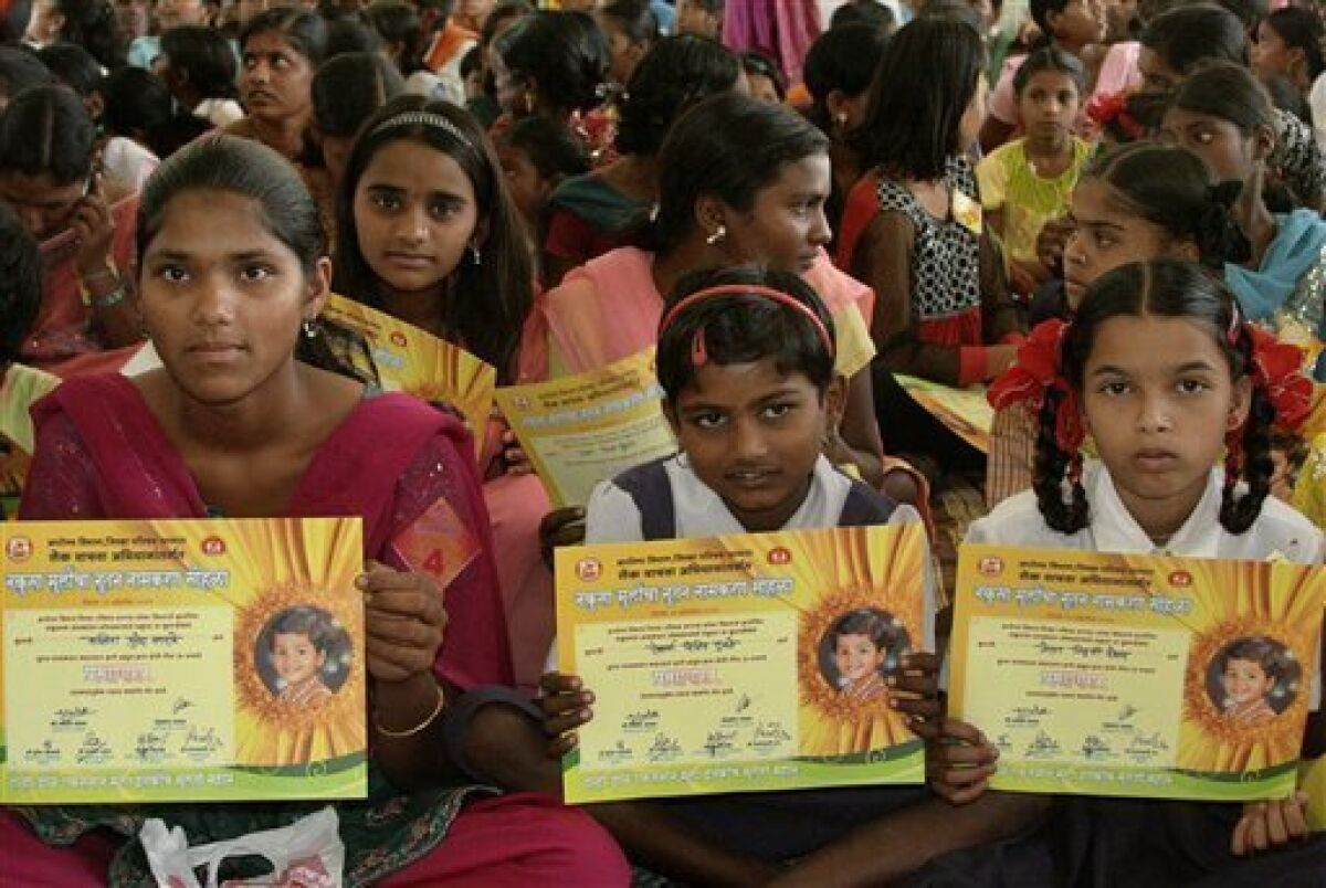 Girls hold certificates stating their new official names during a renaming ceremony in Satara, India, Saturday, Oct. 22, 2011. Almost 300 Indian girls known officially as "Unwanted" have traded their birth names for a fresh start in life. Given names like "Nakusa" or "Nakushi" _ or "unwanted" in Hindi _ they grew up understanding they were a burden in families that preferred boys in Maharashtra state. (AP Photo)