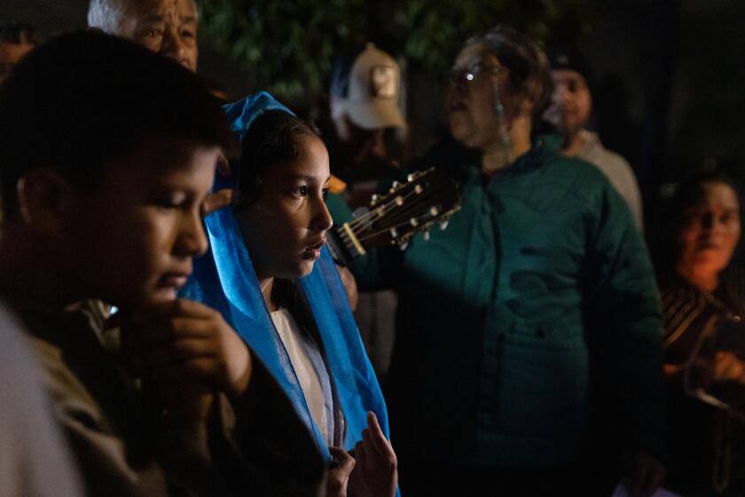 San Diego, California - December 20: Daniel Arenas, 9, as Joseph, left, and Angela Lara, 9, as Virgin Mary, participate in Our Lady of Guadalupe's posada on Wednesday, Dec. 20, 2023 in San Diego, California. The celebration is a reenactment of Mary and Joseph's search for a safe place to give birth to baby Jesus.(Ana Ramirez / The San Diego Union-Tribune)