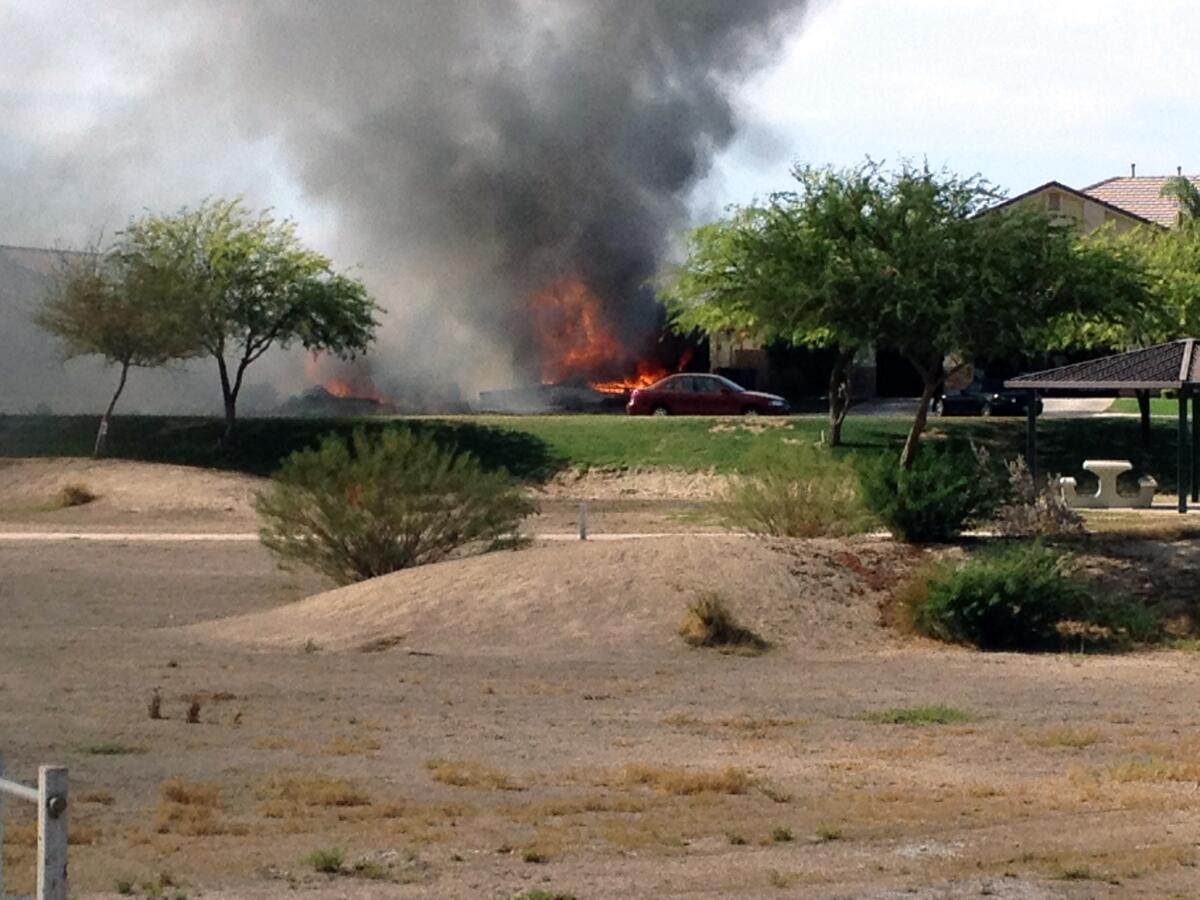 This photo provided by a witness shows a fire caused when a military jet crashed in a residential neighborhood in the Southern California city of Imperial on Wednesday.