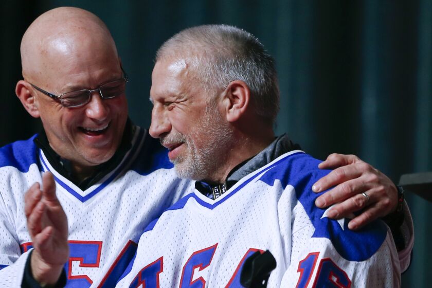 FILE - In this Feb. 21, 2015, file photo, Jack O'Callahan, left, and Mark Pavelich of the 1980 U.S. ice hockey team.