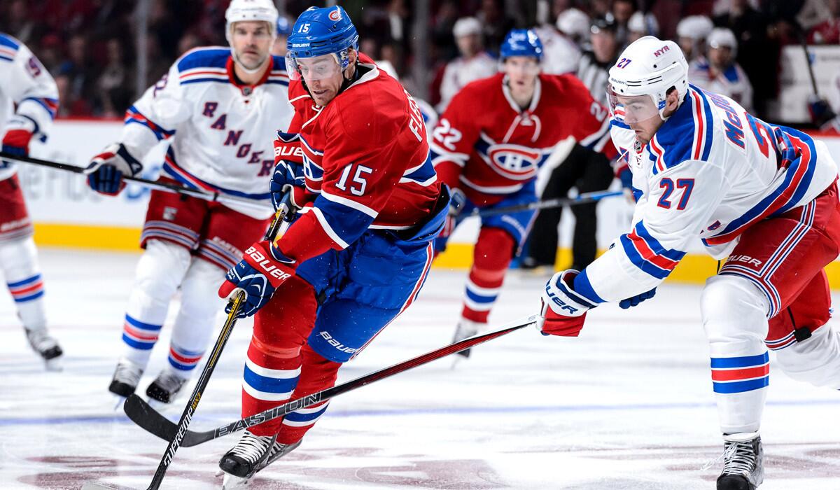 Montreal Canadiens' Tomas Fleischmann tries to move the puck past New York Rangers' Ryan McDonagh during a game on Thursday.