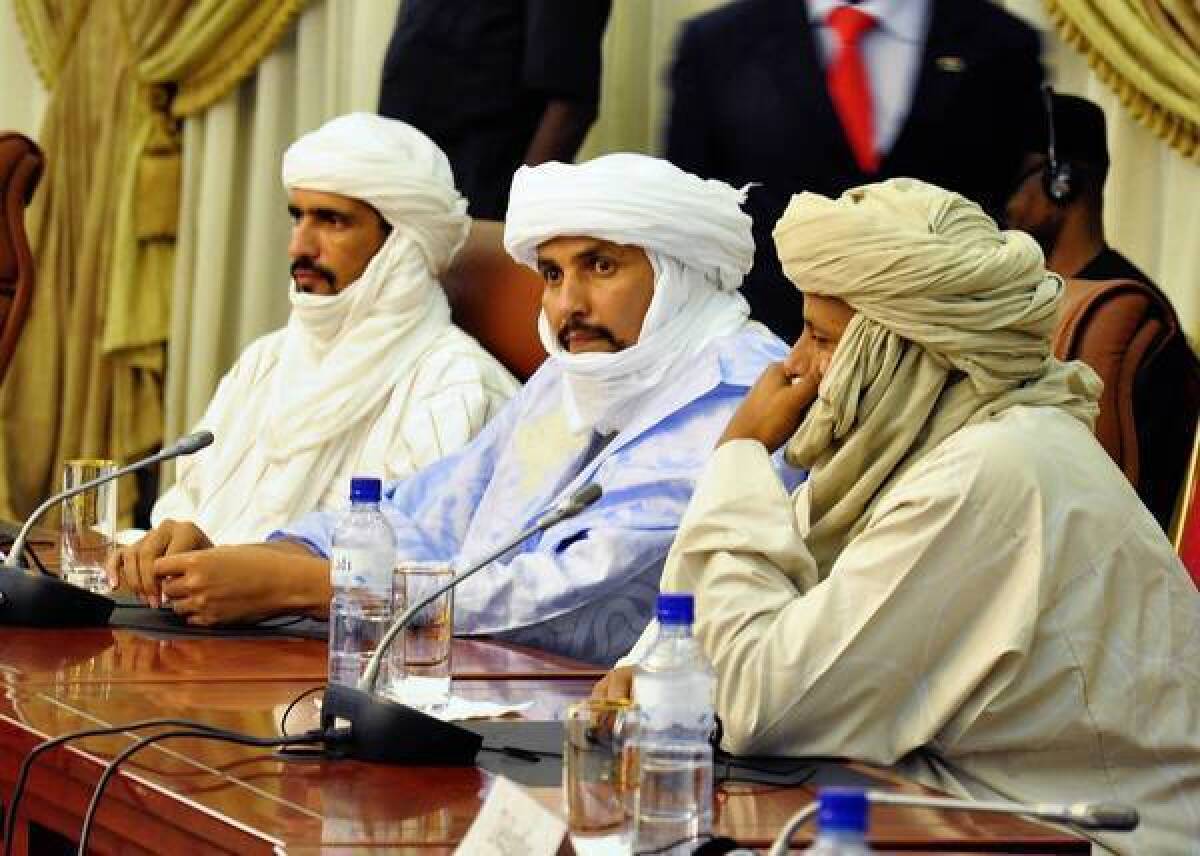 Algabass Ag Intalla, center, leads a delegation from the Islamist group Ansar Dine at a meeting on the Mali crisis this week in Burkina Faso, at which the group pledged to reject terrorism.