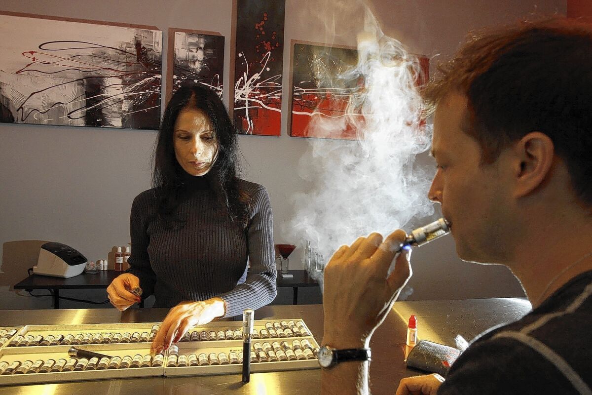 Jason Wingo, 42, vapes at Natural Vapes in Los Angeles as Elaine Ruggieri looks on. San Francisco voters overwhelmingly voted down a proposition aimed at overturning the city's ban on the sale of electronic cigarettes.