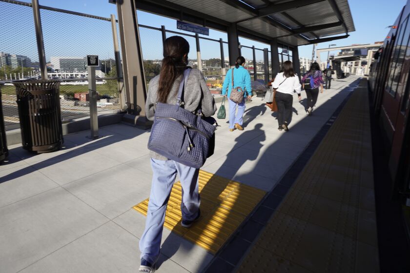 San Diego, CA - March 22: On Tuesday, March 22, 2022 in San Diego, CA. Juliet Jules, 52 a nurse with UC San Diego exited the MTS Trolley Blue Line at the UC San Diego Health La Jolla Station. (Nelvin C. Cepeda / The San Diego Union-Tribune)