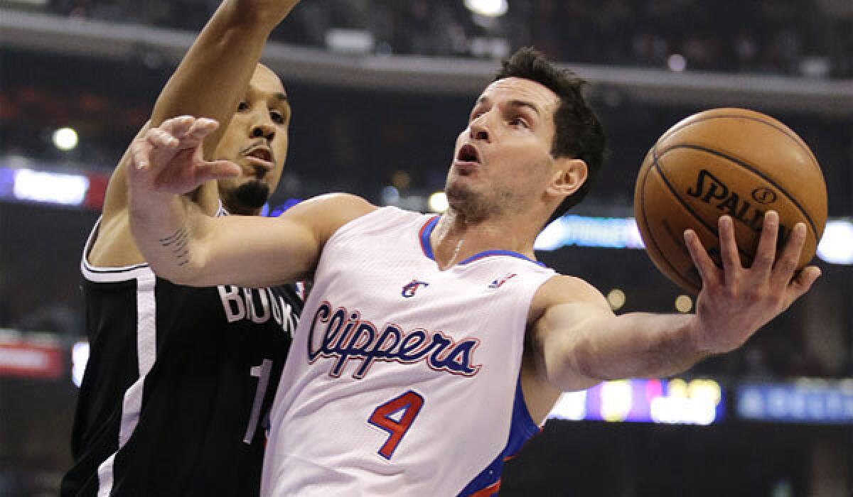 The Clippers' J.J. Redick, right, goes up for a basket against Brooklyn's Shaun Livingston.