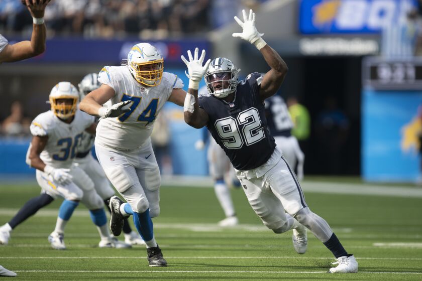 Dallas Cowboys defensive end Dorance Armstrong (92), right, sprints past Los Angeles Chargers offensive tackle Storm Norton (74) during an NFL football game Sunday, Sept. 19, 2021, in Inglewood, Calif. (AP Photo/Kyusung Gong)