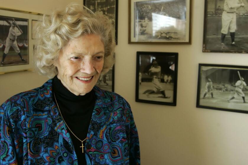 Julia Ruth Stevens, daughter of Babe Ruth, stands by photographs of her father at her home in Sun City, Ariz., Sunday March 26, 2006.(AP Photo/Eric Risberg)