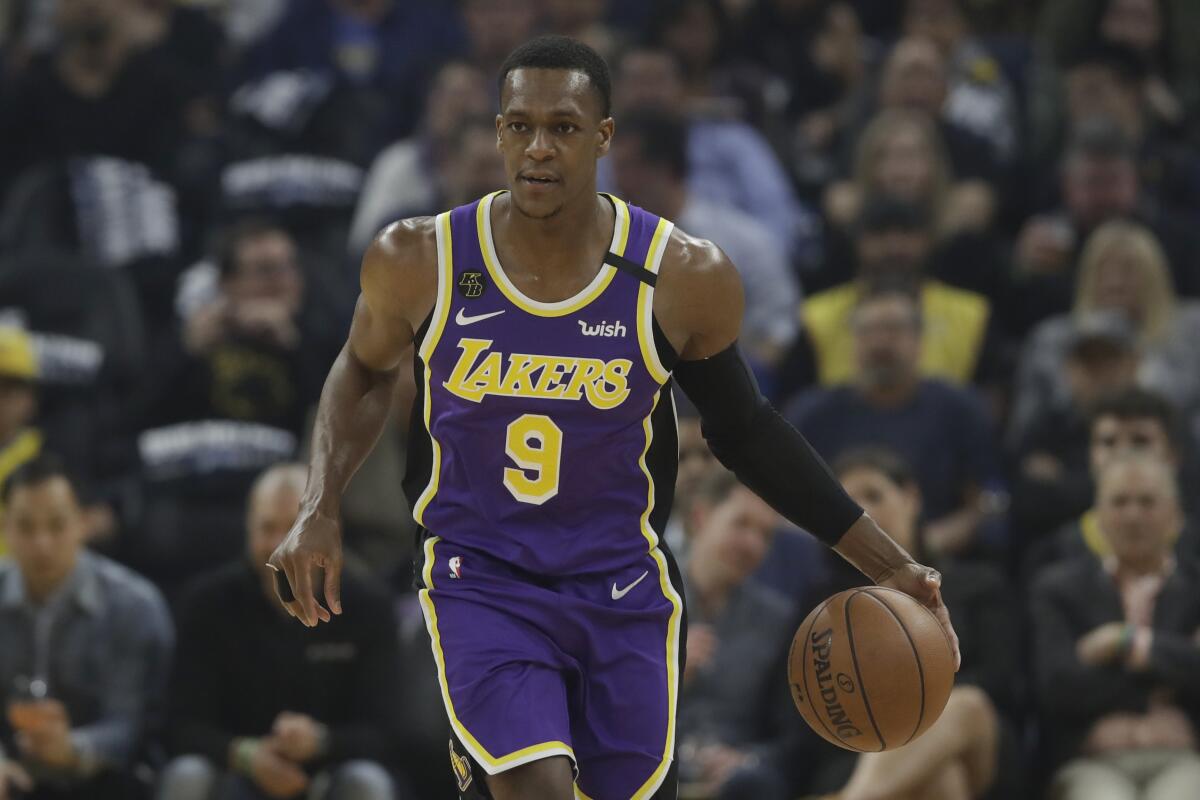 Lakers guard Rajon Rondo dribbles against the Warriors.