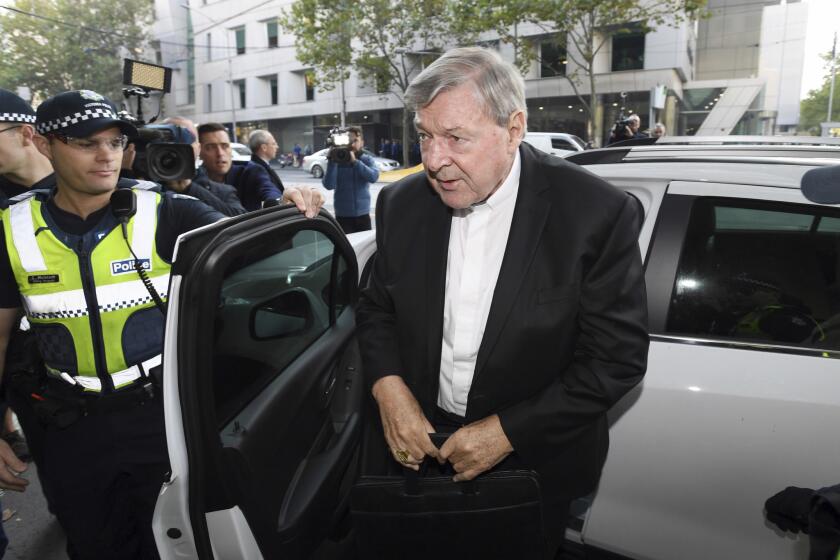 Australian Cardinal George Pell arrives at the Magistrates Court in Melbourne, Australia, Tuesday, May 1, 2018. Pell, the most senior Vatican official to be charged in the Catholic Church sex abuse crisis, arrived surrounded by police and media to learn whether he must stand trial on charges that he sexually abused multiple victims decades ago. (Joe Castro/AAP Image via AP)