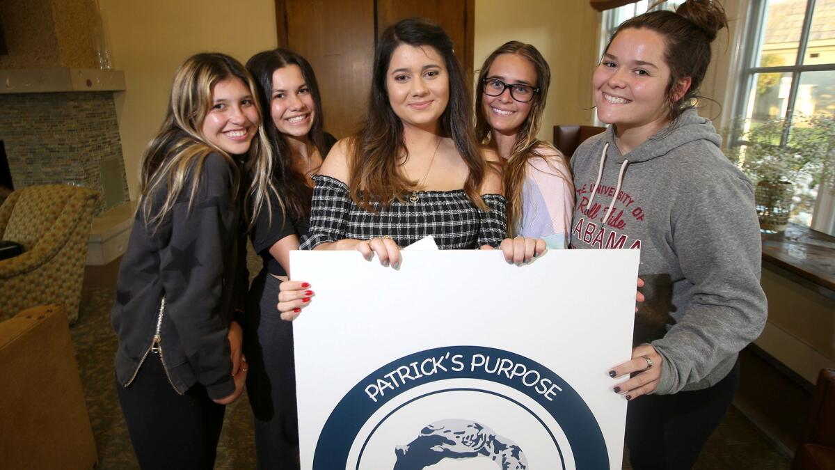 Gabriella Knox, center, stands with friends during her book launch party for "In the Arena: A Story about Teenage Mental Health" with the nonprofit Patrick's Purpose on Tuesday.