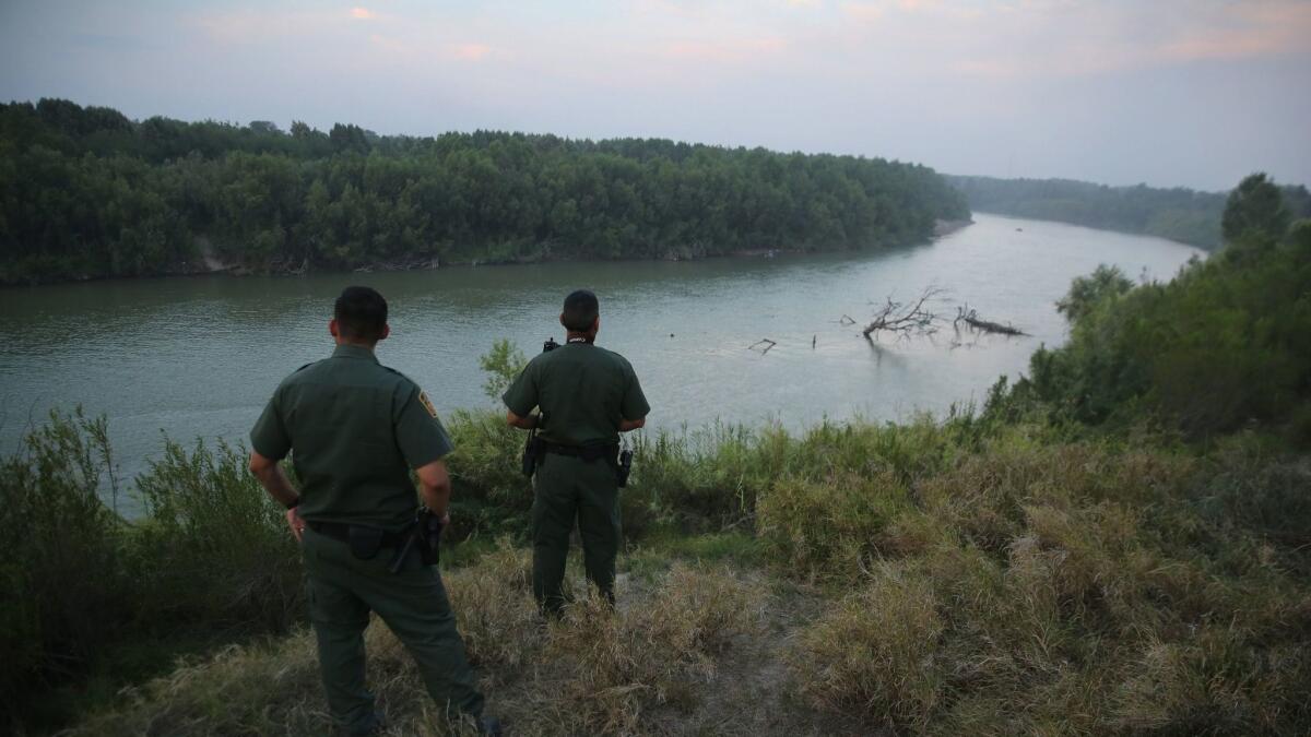 U.S. Border Patrol agents look for immigrants crossing the Rio Grande from Mexico to the United States.