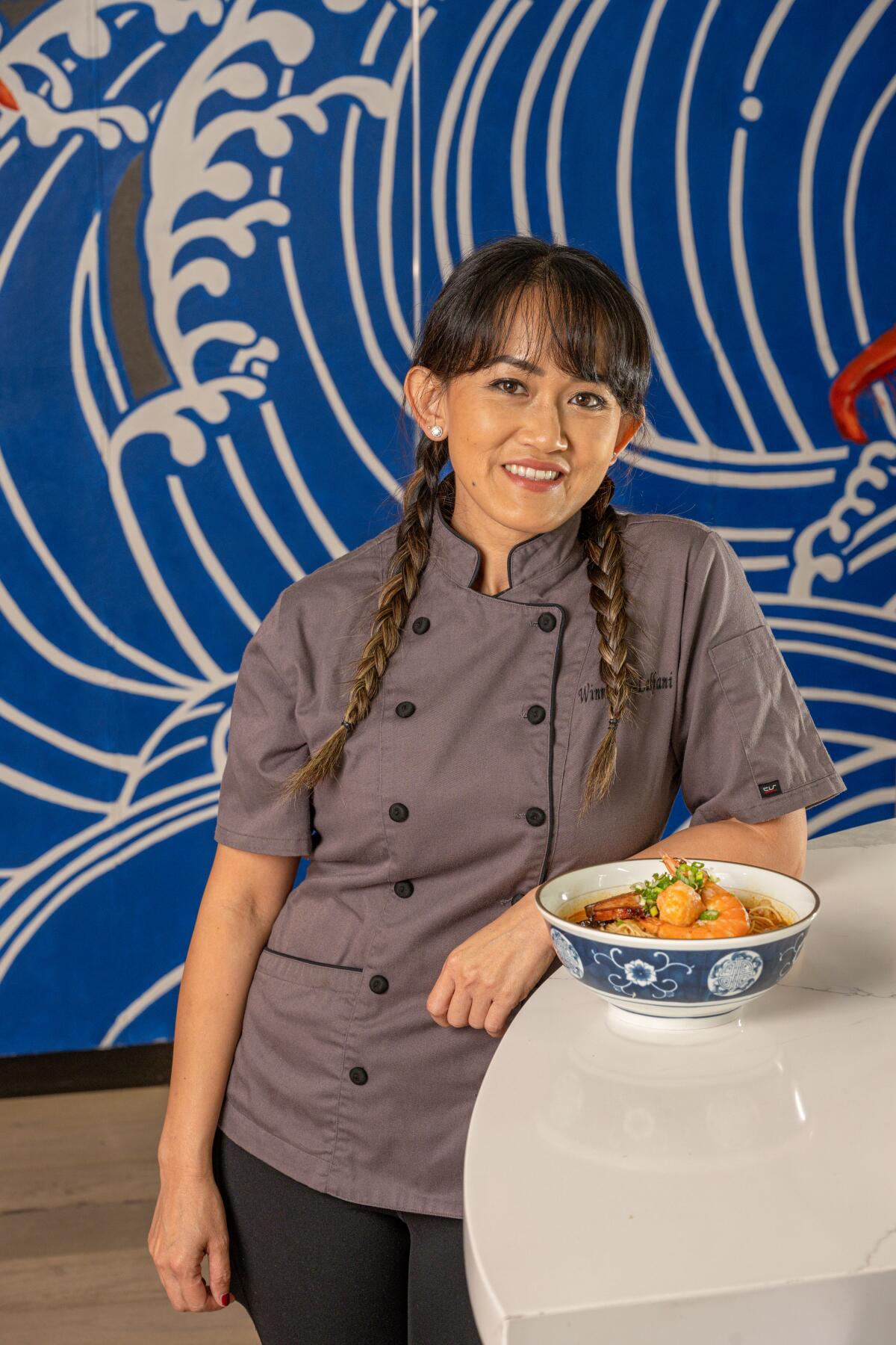 SmokeQueen, Winnie Yee-Lakhani stands beside a bowl of pork belly char siu.