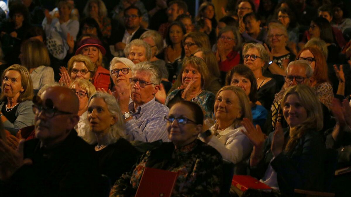 Audience applauds during the introduction of Susan Orlean.