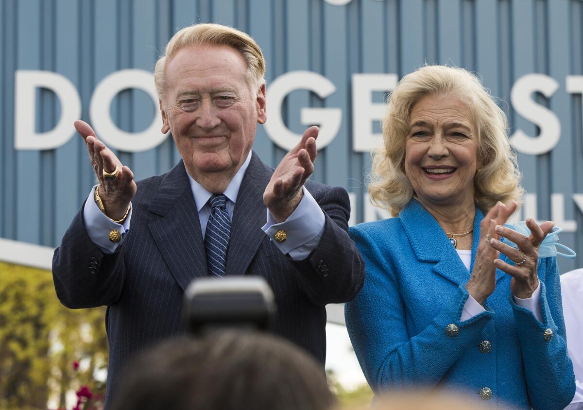 Dodgers broadcasting legend Vin Scully, left, stands next to his wife, Sandra, as he thanks fans.