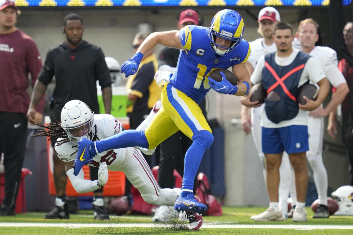 Rams wide receiver Cooper Kupp runs past Arizona Cardinals safety Andre Chachere after making a catch in the first quarter.