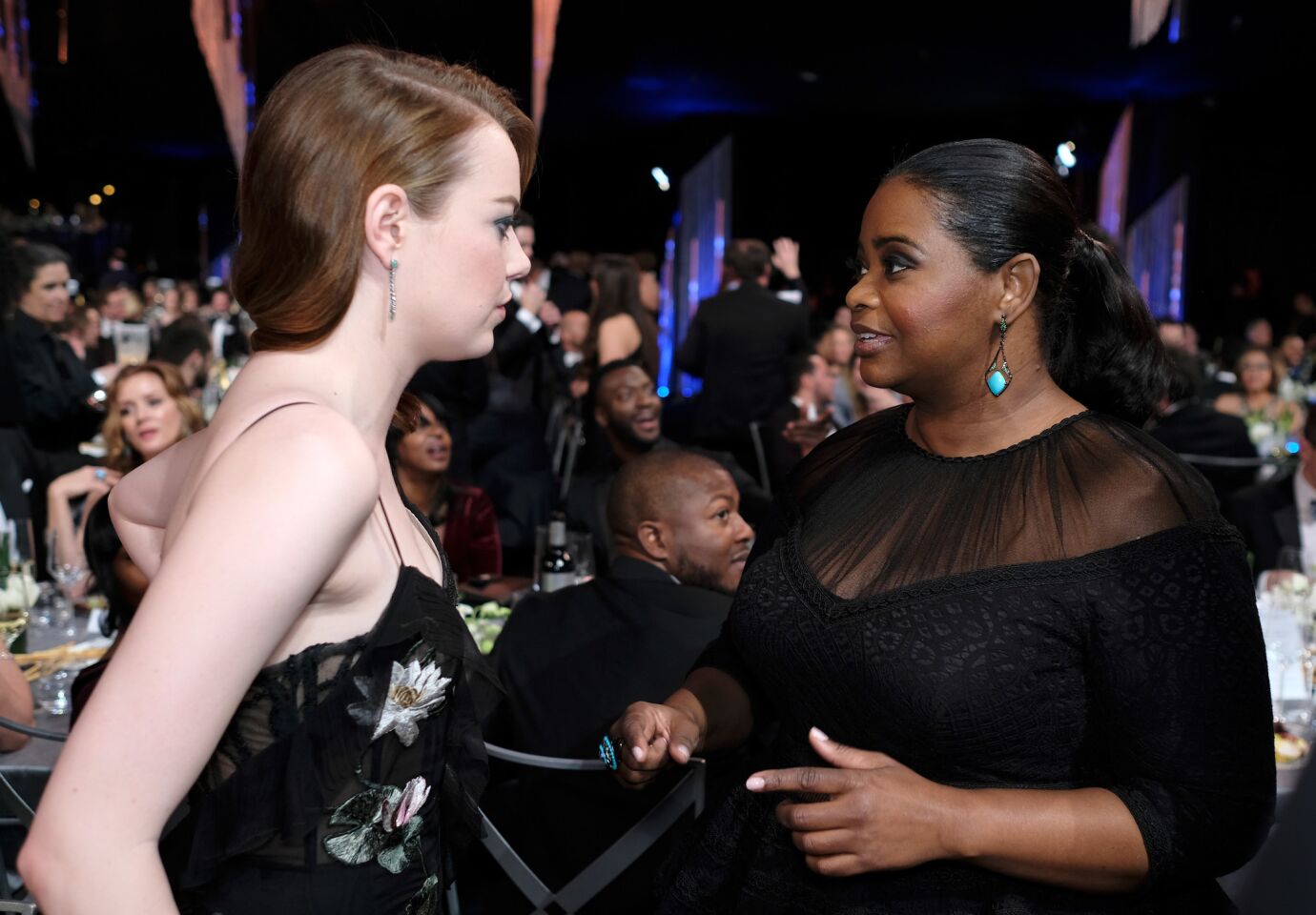 Emma Stone, left, chats with and Octavia Spencer.