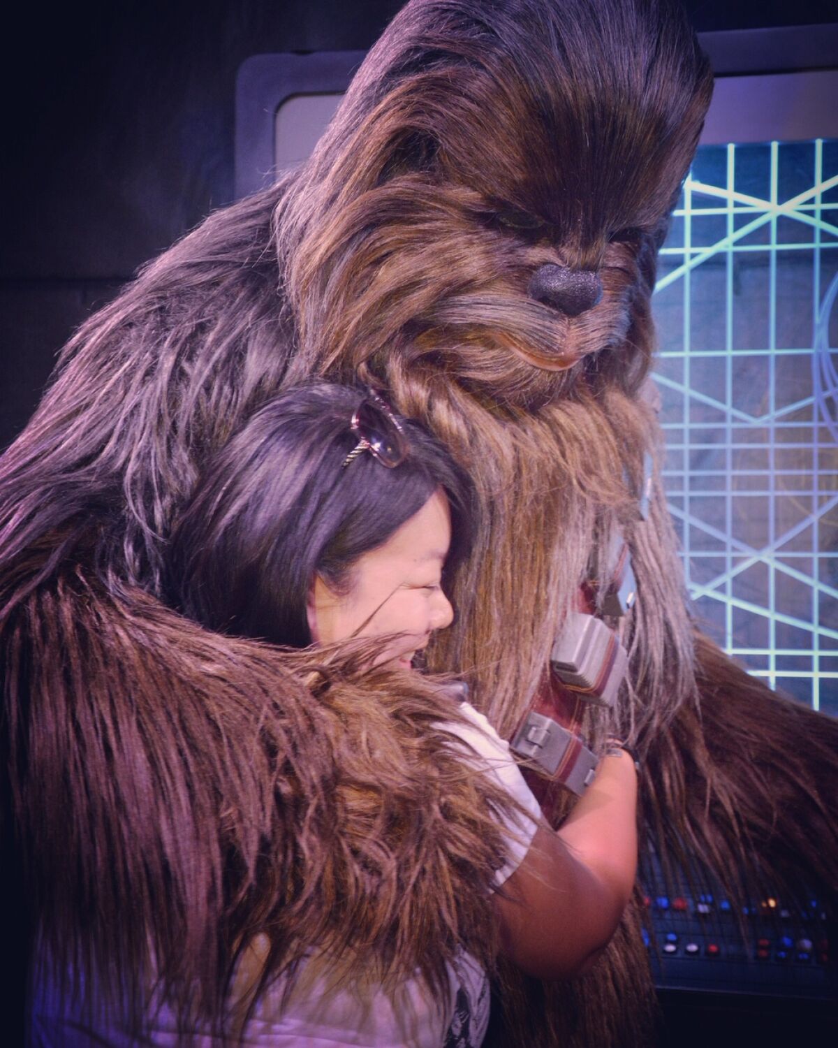 Cindy Hoang, 31 of Westmister, hugs Chewbacca at the Star Wars: Galaxy's Edge area of Disneyland.