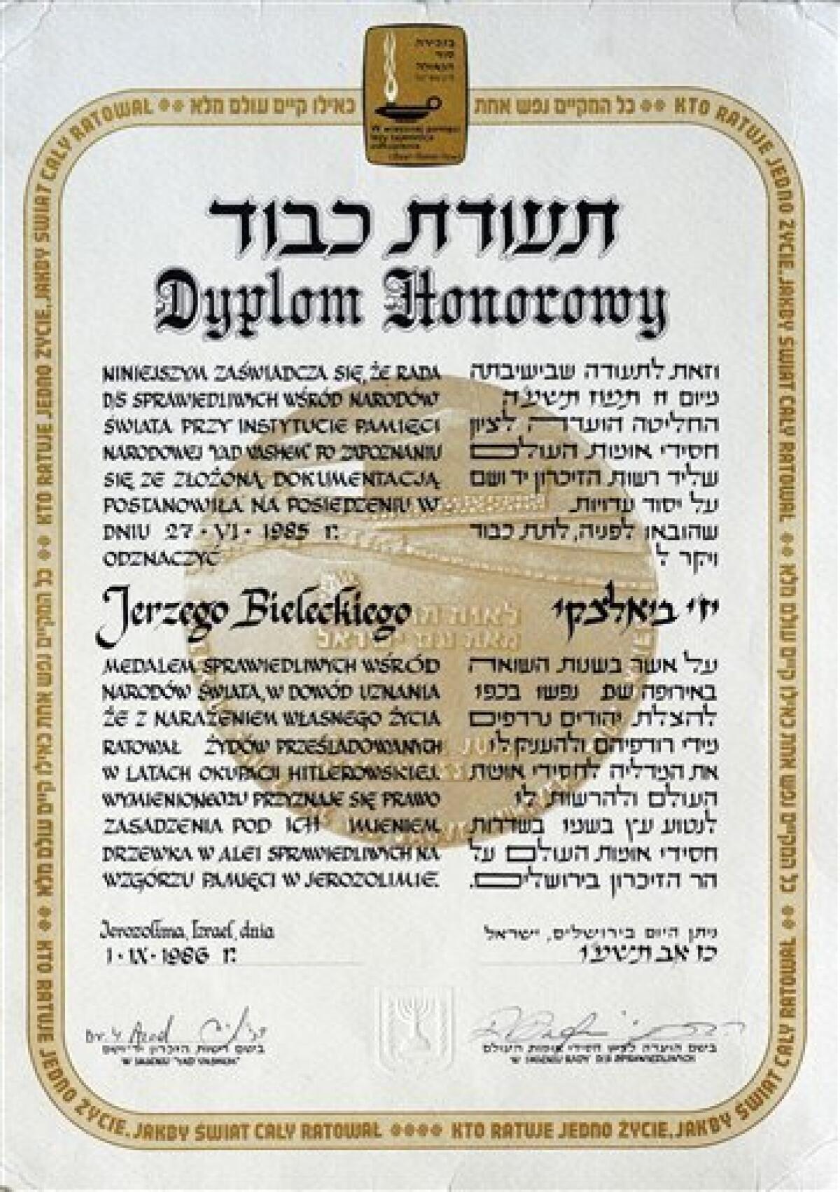 In this May 11, 2010 photo a copy of the diploma from the Yad Vashem Institute in Jerusalem awarding Jerzy Bielecki the Righteous Among the Nations title for saving Cyla Cybulska, is seen in Nowy Targ, southern Poland. 60 years ago Bielecki, then an Auschwitz Birkenau prisoner, escaped from the death camp with his Jewish girlfriend, Cyla Cybulska. (AP Photo/Alik Keplicz)