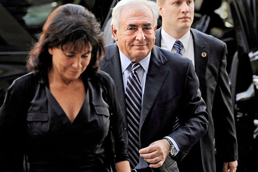 Dominique Strauss-Kahn, the former director of the International Monetary Fund, and his wife, Anne Sinclair, left, arrive to state Supreme Court in New York. Prosecutors in the case have filed a recommendation to dismiss the charges against Strauss-Kahn that he sexual assaulted a hotel maid on May 14, 2011.
