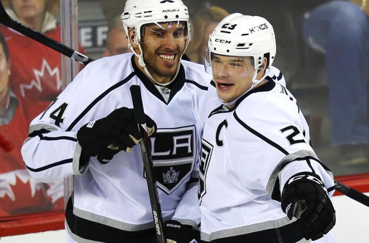 Kings forward Dwight King celebrates with captain Dustin Brown after scoring a goal against the Calgary Flames in the third period of a 2-0 victory on Thursday night.