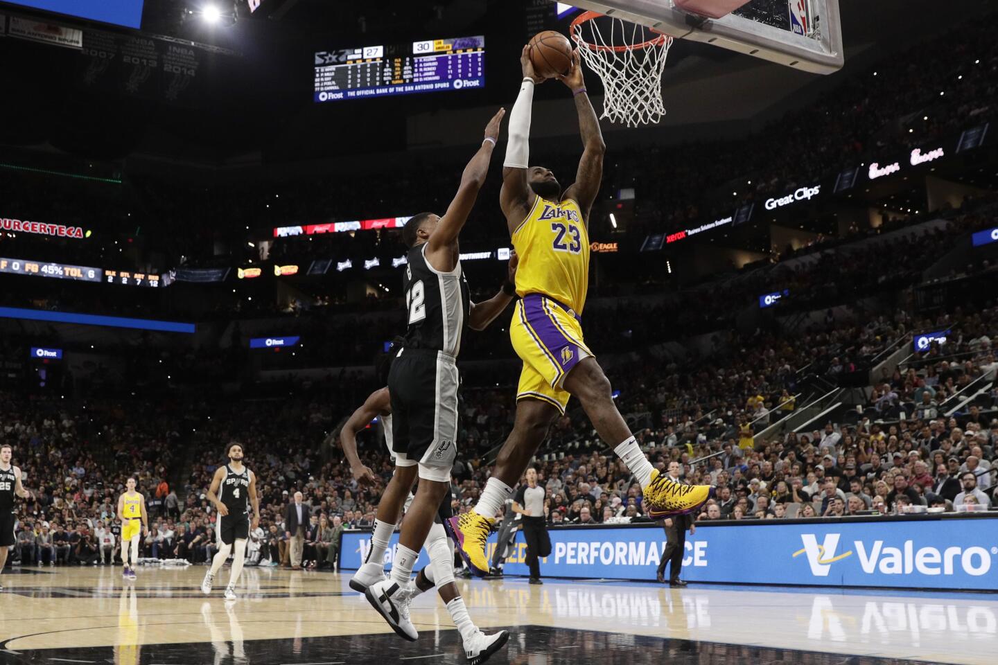 Lakers forward LeBron James (23) dunks the ball ahead of Spurs forward Rudy Gay (22) during the first half of a game Nov. 25.