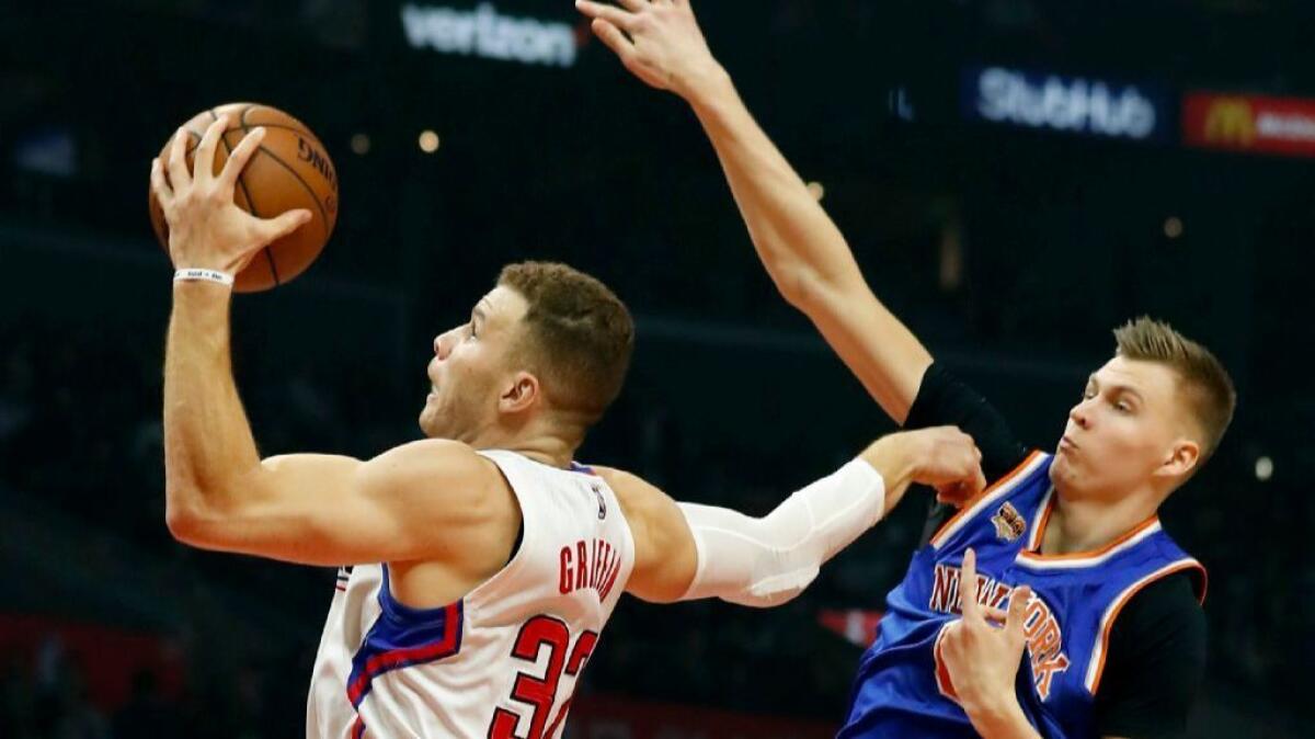 Clippers forward Blake Griffin, left, catches a pass next to Knicks forward Kristaps Porzingis during the first half on March 20.