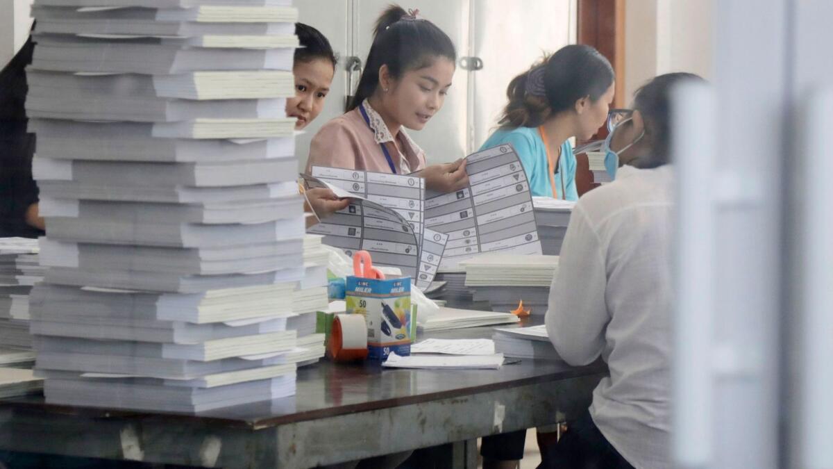 Cambodian workers organize ballot papers at a printing house in Phnom Penh, the capital, on June 15, 2018.