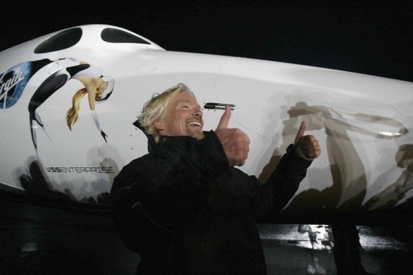 Richard Branson celebrates at Mojave Air and Space Port as the VSS Enterprise makes its debut. About 300 people have paid $200,000 each to be among the first passengers to travel in space.