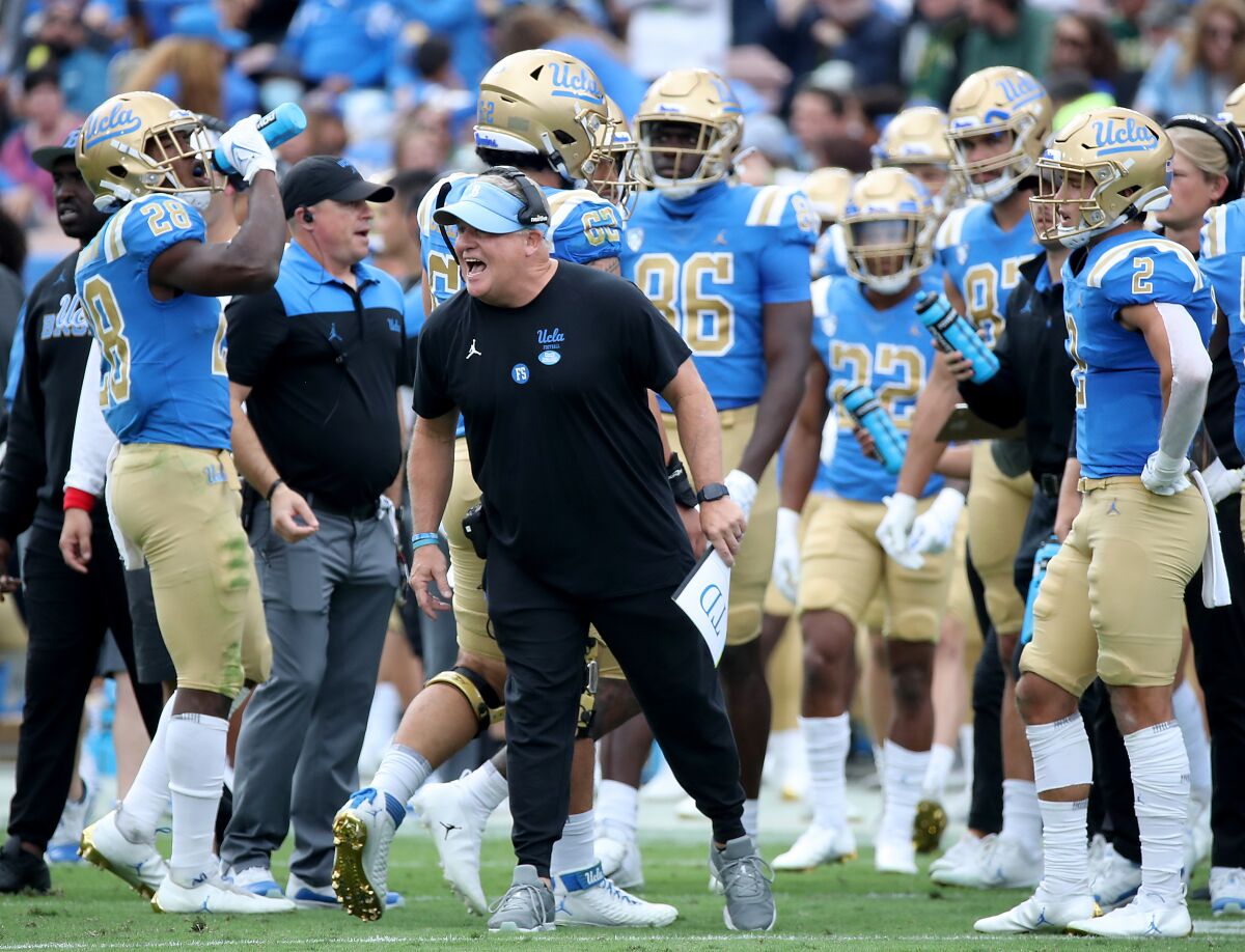 UCLA head coach Chip Kelly shouts instructions to his team from the sideline.