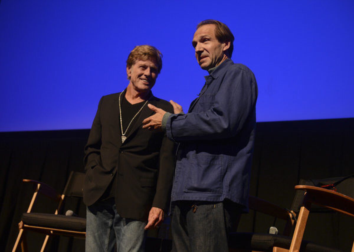 Robert Redford accepts his Silver Medallion from actor Ralph Fiennes at the 2013 Telluride Film Festival in Telluride, Colo.