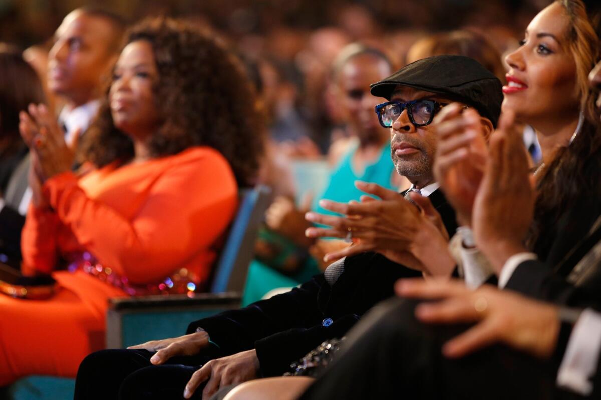 Director Spike Lee sits across the aisle from Oprah Winfrey at the 46th NAACP Image Awards at Pasadena Civic Auditorium.
