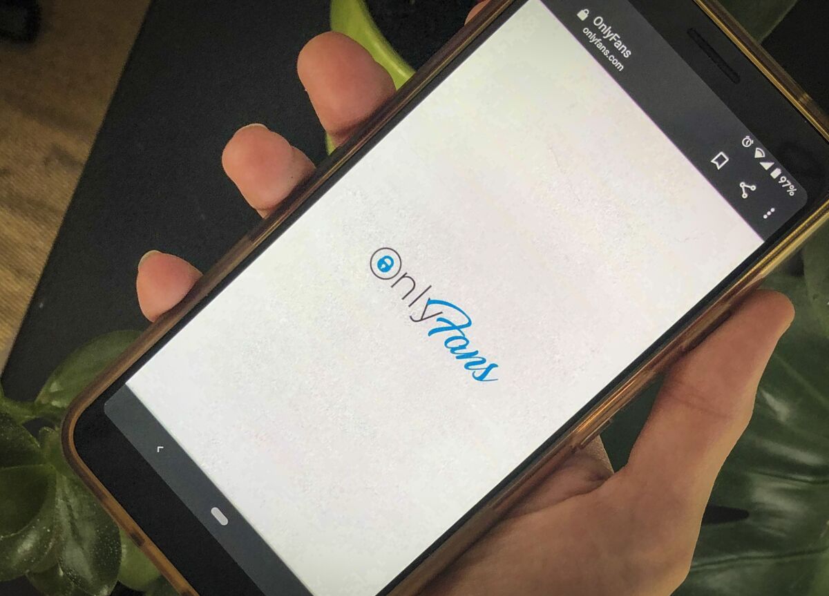 The OnlyFans app is displayed on a smartphone.
