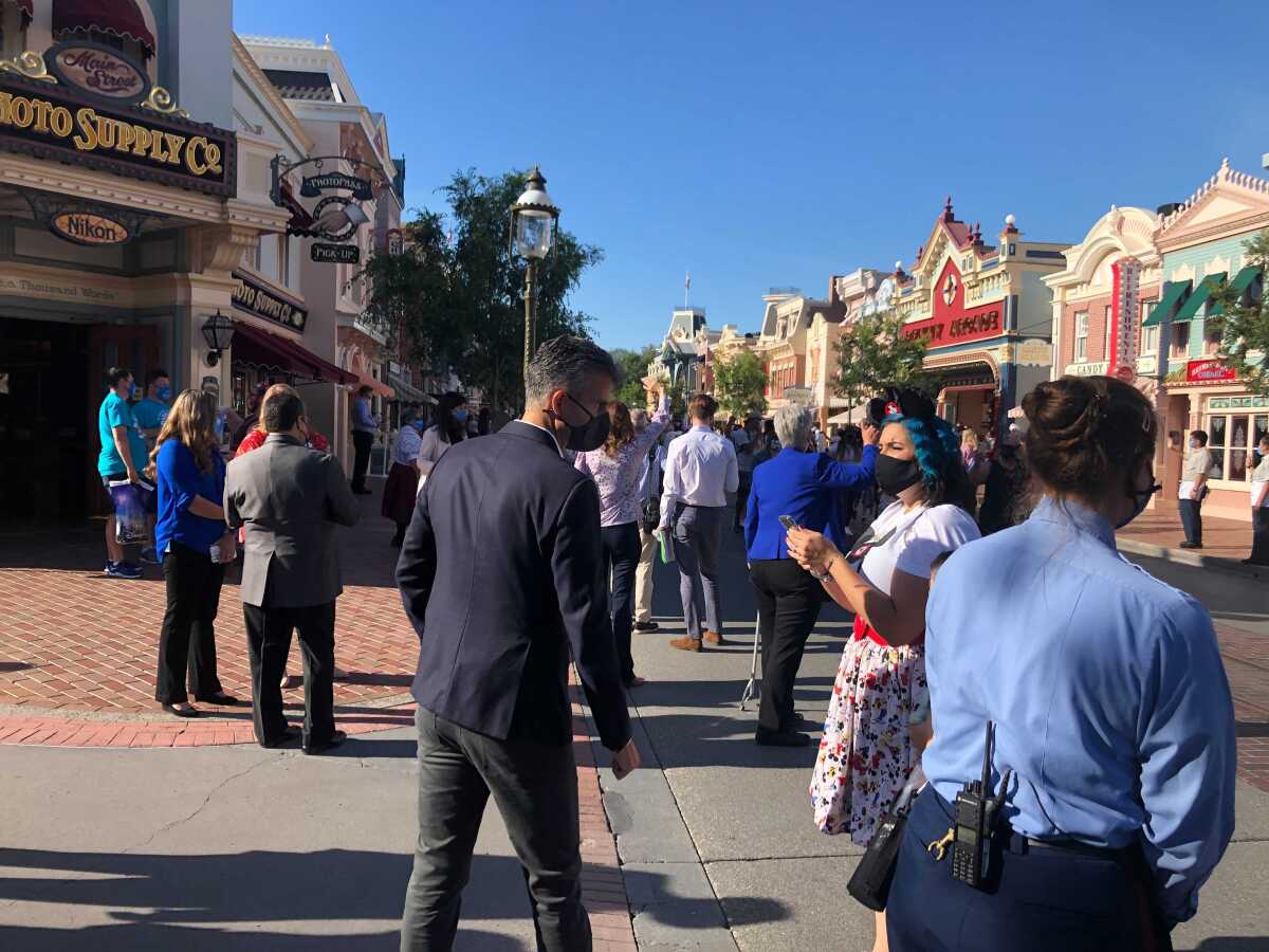 Disneyland workers line the park's Main Street USA to greet guests