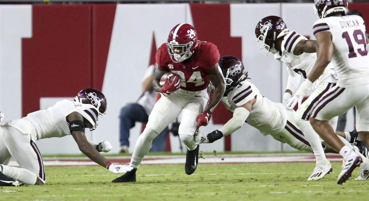 Mississippi State tacklers surround and bring down Alabama running back Trey Sanders (24) during an NCAA college football game Saturday, Oct. 31, 2020, in Tuscaloosa, Ala. (Gary Cosby Jr./The Tuscaloosa News via AP)