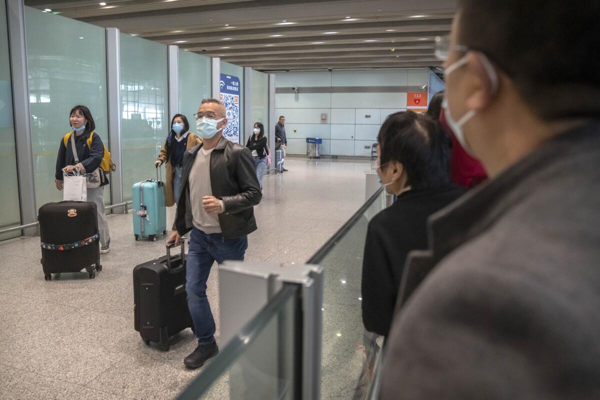 Travelers wearing face masks at Beijing airport