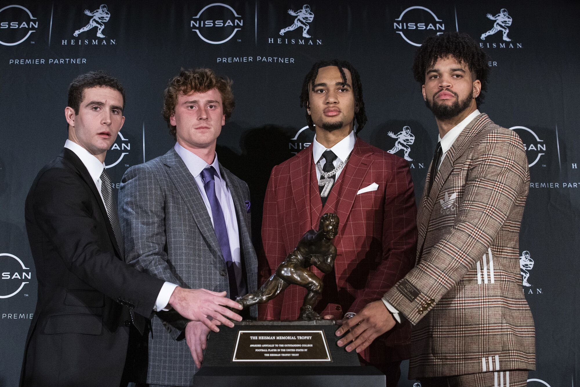 The Heisman trophy finalists stand for a photo with the trophy before attending the award ceremony in New York.