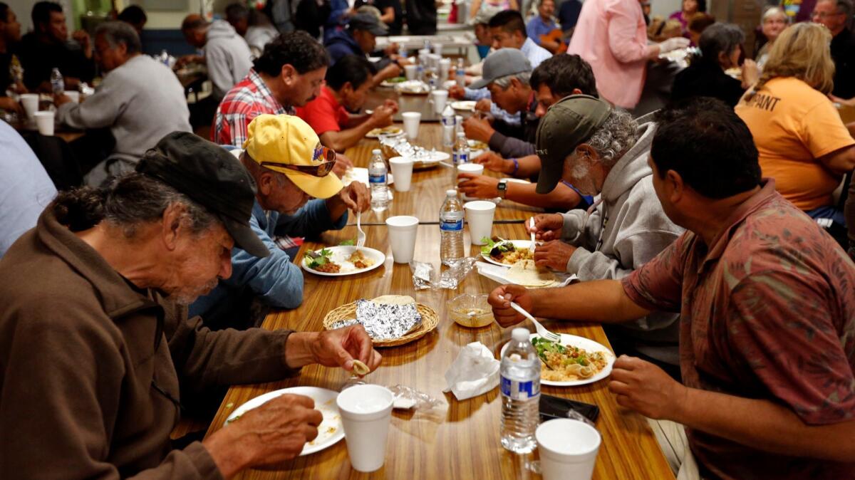 Homeless men, most of them undocumented Latinos, have a meal at a facility that also offers shelter in Los Angeles.