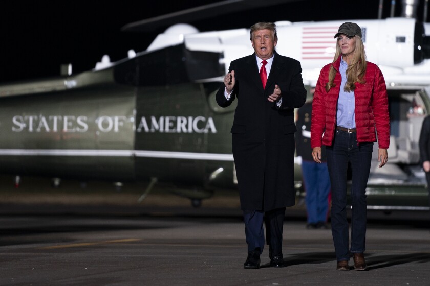 Kelly Loeffler and Donald Trump walking away from the president's helicopter, Marine One.