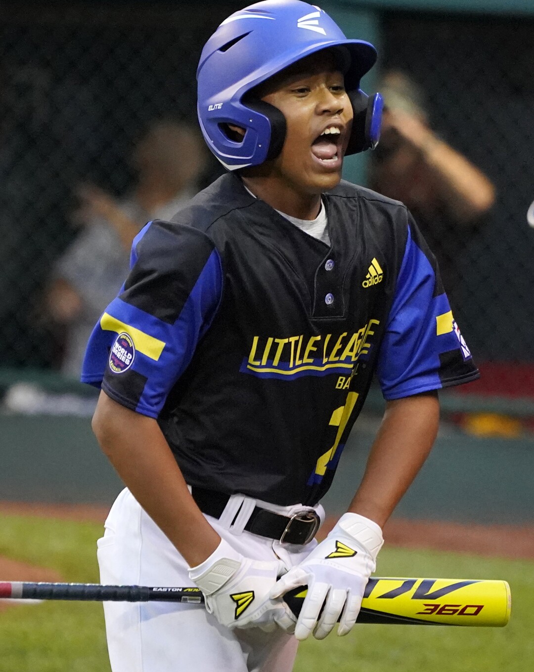 Torrance, Calif.'s Elias Emerson (21) celebrates as he returns to the dugout after scoring.