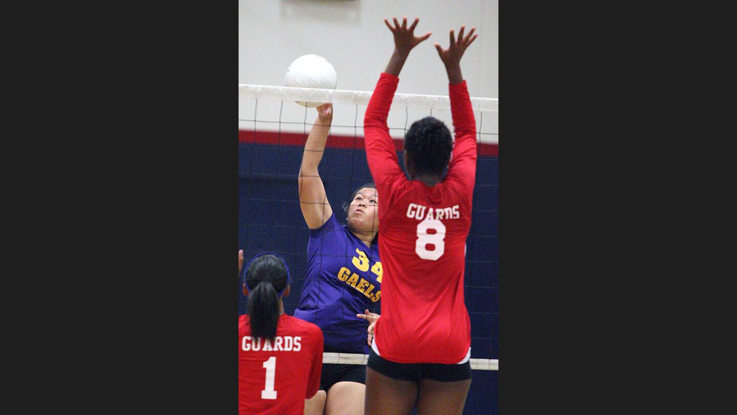 Holy Family's Isabella Peregrino hits a kill by the defense of Bell-Jeff's Claire Borot in a non-league girls' volleyball match at Bell-Jeff High School on Thursday, August 24, 2017.