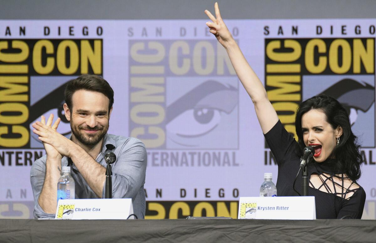Charlie Cox (Daredevil) and Krysten Ritter (Jessica Jones) at the "Marvel's The Defenders" panel at Comic-Con on Friday night.