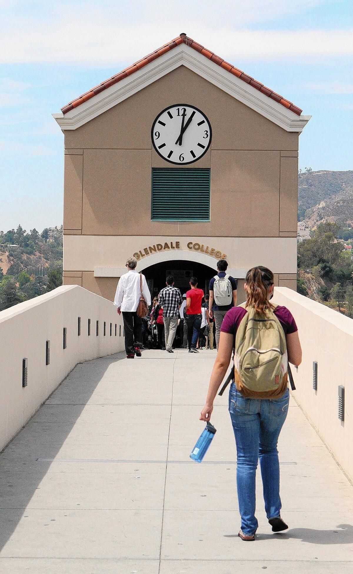 Students cross the parking bridge to the elevators to campus at Glendale Community College on the first day of classes for the 2014 Fall semester on Monday, August 25, 2014.