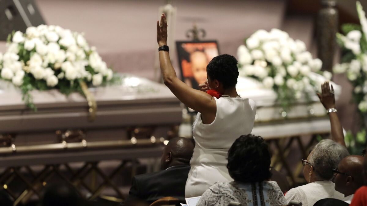 A member of the Coleman family stands during a musical selection at the funeral in Indianapolis on Saturday for five members of the family killed in a duck boat accident in Missouri.