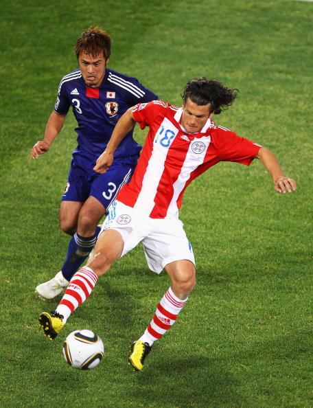 Yuichi Komano of Japan closes down Nelson Valdez of Paraguay during the 2010 FIFA World Cup South Africa Round of Sixteen match between Paraguay and Japan at Loftus Versfeld Stadium on June 29, 2010 in Pretoria, South Africa.